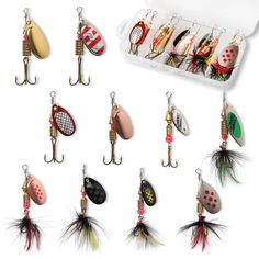 various types of fishing lures and hooks in an open box on a white background