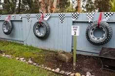 there are three tires hanging on the fence