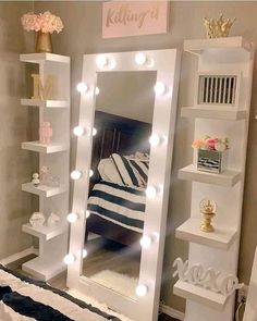 a mirror that is sitting on top of a shelf next to a bed with lights