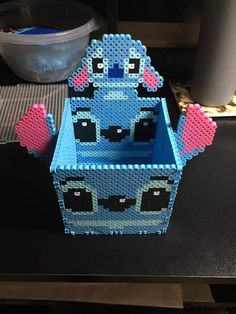 a blue lego box sitting on top of a table next to a bowl and spoon