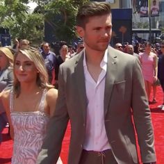 a man and woman walking down a red carpet