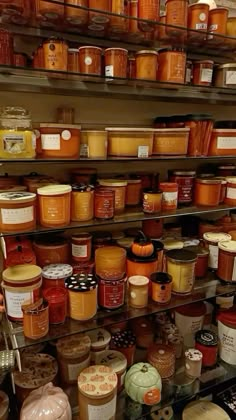 shelves filled with lots of different types of jars and sauces on top of each other