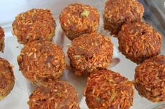 several balls of food sitting on top of a white tray