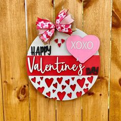 a valentine's day sign hanging on a wooden fence