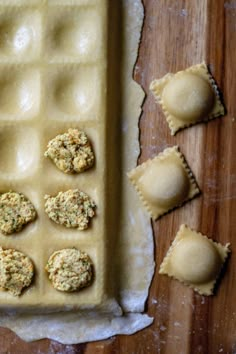 some food is laying out on a wooden table and ready to be baked in the oven