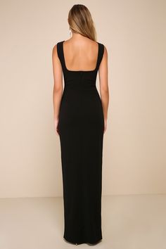 the back of a woman wearing a long black dress with spaghetti straps and open shoulders