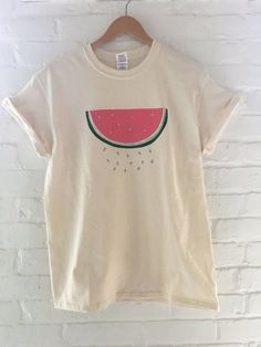 "Hand Printed and Hand Drawn! This is a 100% cotton screen printed t shirt with a hand drawn watermelon. It's perfect for summer! The shirt shown here is natural cotton and is printed in red and green ink. If you are interested in a different color shirt, just message us and ask! // PROCESS: All of our items are individually hand printed by either me or my dad, which can lead to slight variations in placement. The ink is heat cured and will not fade over time. Since our items are printed to orde Screen Print Shirt, Watermelon Tshirt, Watermelon Shirt, Fruit Shirt, Food Shirt, Screen Printing Shirts, Fruit Print, Color Shirt, Shirt Pattern