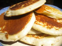 pancakes stacked on top of each other on a blue and white plate