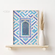 a white vase sitting on top of a wooden shelf next to a blue and white tile wall