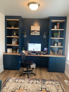 a home office with built - in shelving and desk