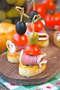 small sandwiches with olives, tomatoes and ham