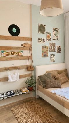 a bed room with a neatly made bed and pictures on the wall