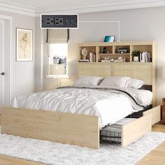 a bed sitting in a bedroom next to a book shelf on top of a wooden headboard