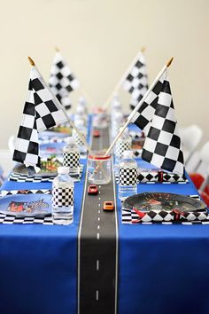 the table is decorated with racing flags and race cars