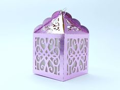 a purple candle holder sitting on top of a white table