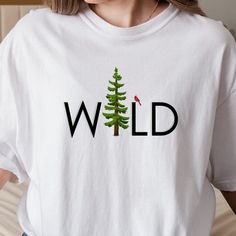 Cute nature tee with "Wild" as the main focus. With a pine tree as the "I" and a cardinal on the "L" this shirt design has attention to detail, down to the slight green shadowing of the letters. If you're looking for a uniquely wild tshirt, this tree and bird shirt is perfect for you. Unisex sizing makes this perfect for an outdoorsy dad gift, or as an oversized tee for comfy summer days. Soft tshirt available in three colors, sizes small to 3XL. #WildWoman #NatureLover #AdventureStyle #E... Outdoorsy Women, Granola Girl Style, Farmers Market Tote Bag, Cute Nature, Nature Tees, Bird Shirt, Botanical Shirt, Cottagecore Style, Adventure Style