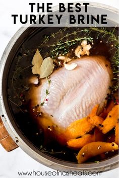 the best turkey brine recipe in a pot with carrots and herbs