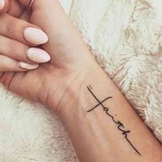 a woman's wrist with a tattoo on it that says love and is written in cursive writing