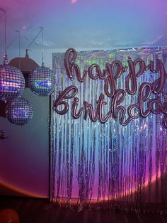 there is a happy birthday sign in front of the disco ball backdrop with lights on it