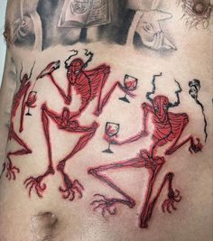 a man's stomach with red ink on it, and some drawings in the shape of skeletons