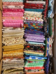 a box filled with lots of different colored fabrics