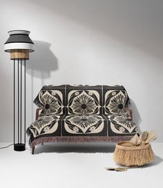 a black and white couch sitting next to a lamp