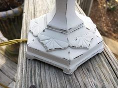 a white vase sitting on top of a wooden table