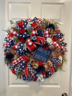 a patriotic wreath is hanging on the front door