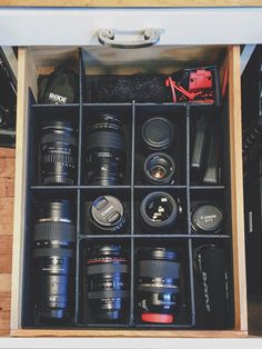 a drawer filled with many different types of cameras