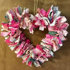 a heart shaped wreath made out of fabric