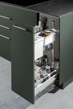 an open cabinet in the middle of a kitchen