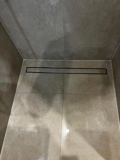 an empty shower stall is shown with the floor in front of it and no door