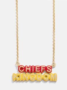 a necklace with the word chiefs kingdom on it, hanging from a gold plated chain