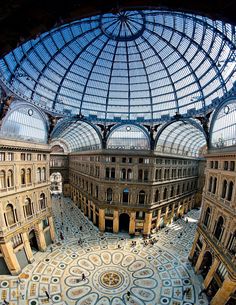 the inside of an old building with many glass domes and arches on it's ceiling