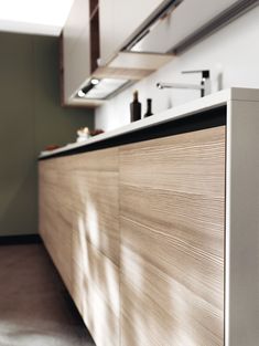 an image of a modern kitchen setting with wood cabinets