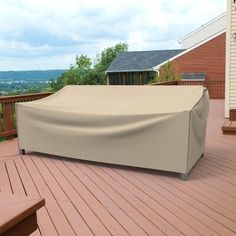 a covered bench on a wooden deck overlooking the valley and trees in the distance with a house in the background