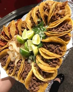 a platter filled with tacos and other foods