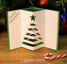 an origami christmas tree card with candy canes