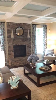 a living room filled with furniture and a fire place in the middle of a room