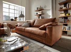 a living room with two couches and a coffee table in front of a window