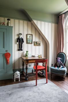 a room with a chair, table and stuffed animal on the floor next to it