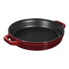 a red cast iron skillet with grilling pans on the bottom and sides