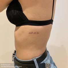 a woman's stomach with the word let it be tattooed on her lower side