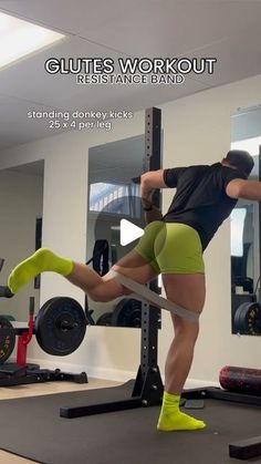 a man is doing squats on a bar in a gym with the caption,'guts workout resistance band '