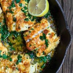 a skillet filled with chicken and broccoli covered in parmesan cheese