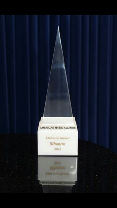 an award is sitting on a table in front of a blue curtain with the name american music awards