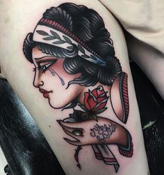 a woman's arm with a tattoo on it and a rose in her hair