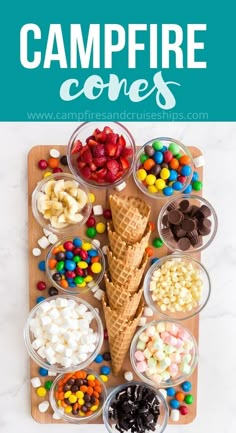 an ice cream cone surrounded by candy and candies on a cutting board with bowls