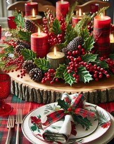 a christmas table setting with candles, holly wreaths and pine cones on the centerpiece