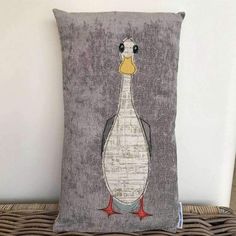 a gray pillow with a white duck on it